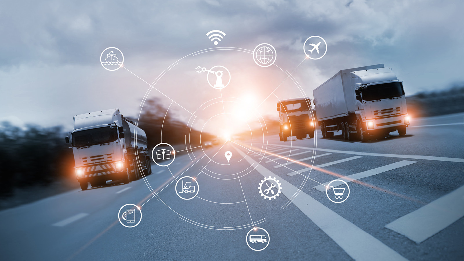 Several trucks are driving on a highway. White icons superimposed on the image show the functional scope of the VDO Tachograph Management software. Among other things, connectivity, maintenance, logistics and other tasks that fleet managers encounter in their day-to-day work are shown.